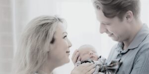 New Mom and Dad lovingly looking at their son after going through the IVF Fertility Journey