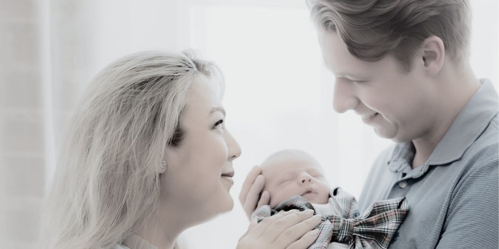 New Mom and Dad lovingly looking at their son after going through the IVF Fertility Journey