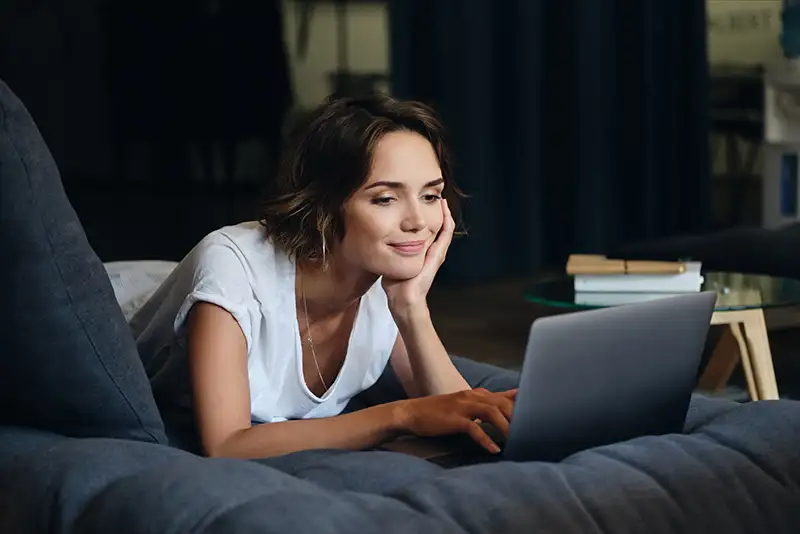Woman completing an online fertility quiz on her laptop to take the first step toward fertility evaluation and treatment at Positive Steps Fertility in Mississippi and Louisiana
