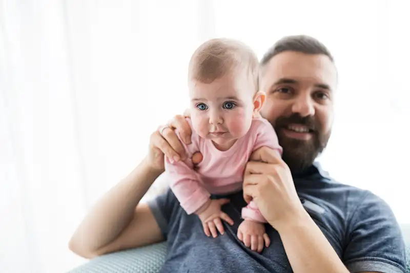 Father smiling while holding his baby after his ICSI treatment journey with Positive Steps Fertility Father smiling while holding his baby after his ICSI treatment journey with Positive Steps Fertility