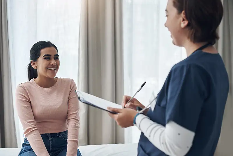 Woman meeting with a fertility nurse before minimally invasive gynecologic surgery at Positive Steps Fertility