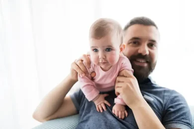 Father smiling while holding his baby after his ICSI treatment journey with Positive Steps Fertility Father smiling while holding his baby after his ICSI treatment journey with Positive Steps Fertility